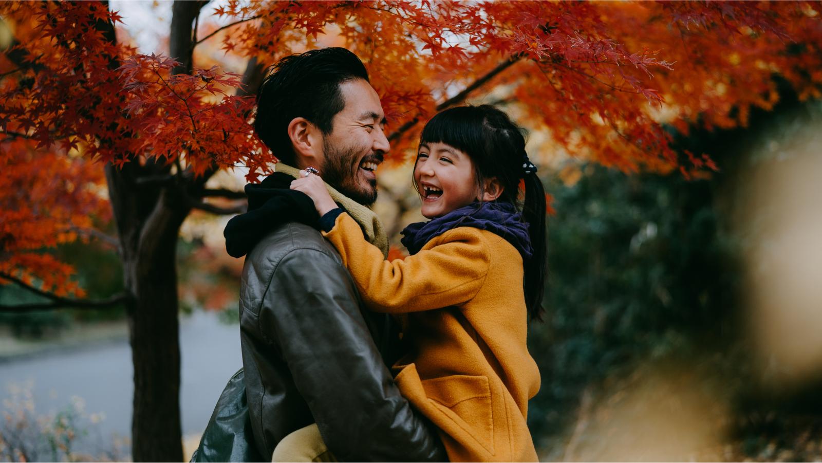 Dad holding daughter during fall