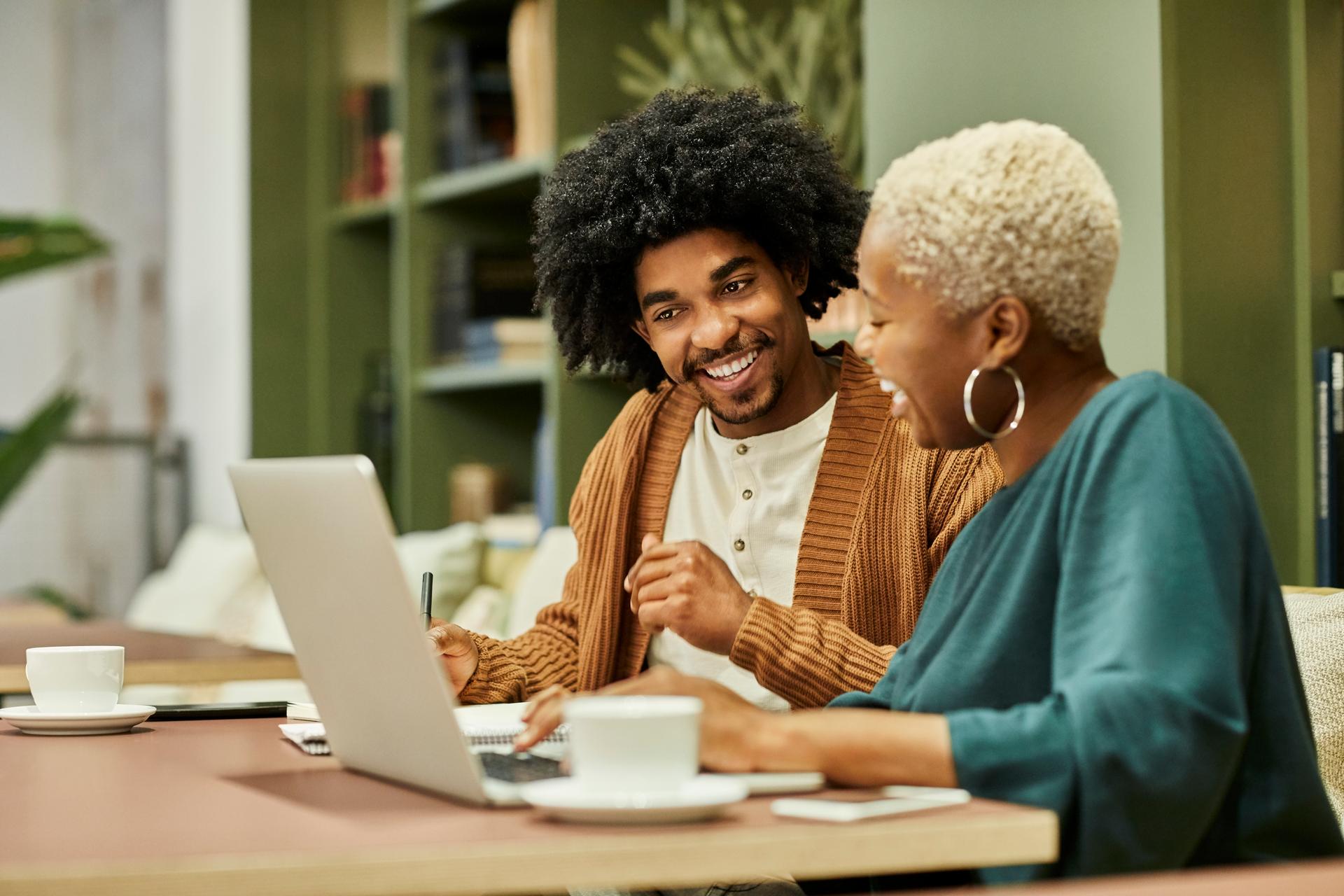 Coworkers discussing at desk in office