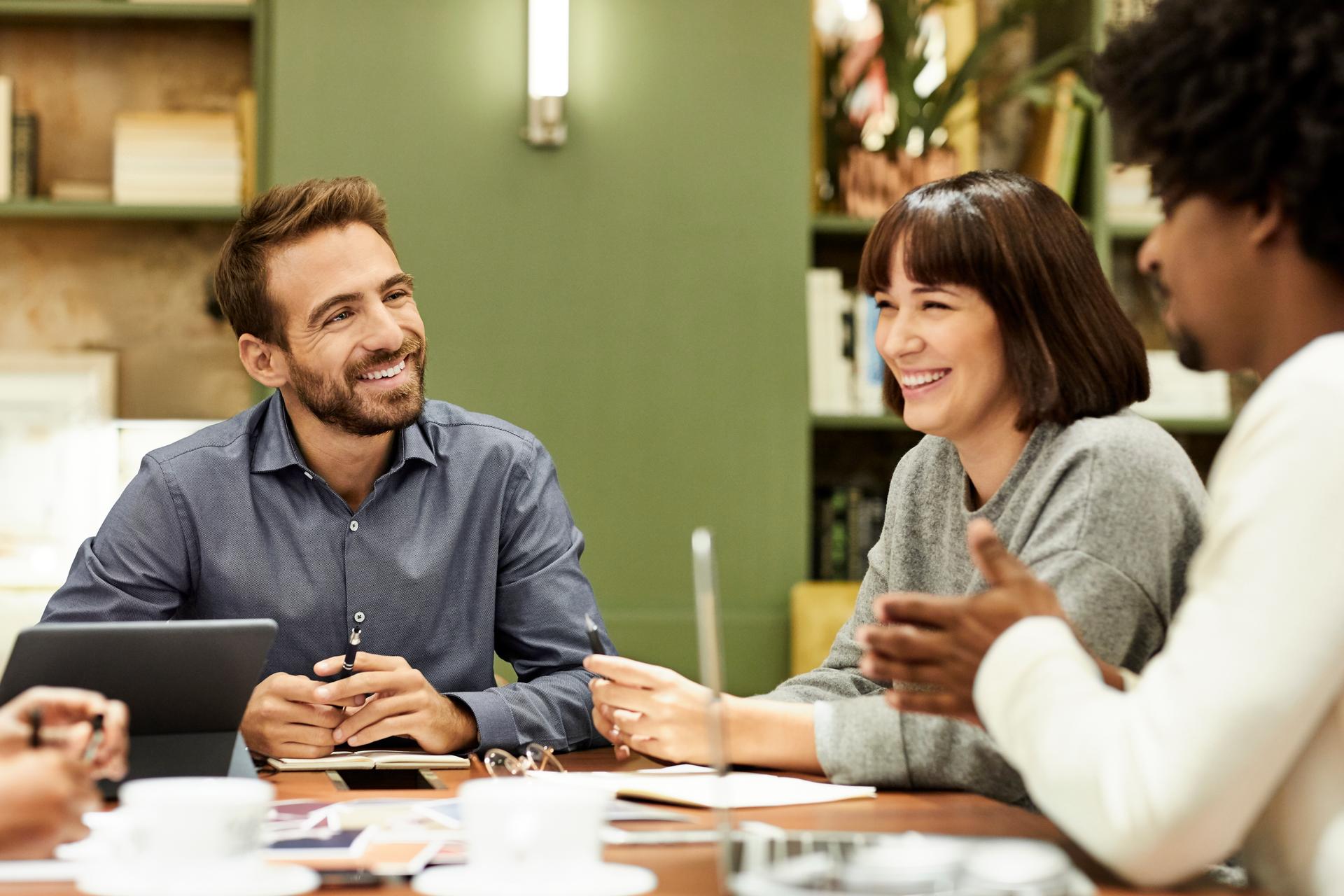Colleagues discussing during meeting in office