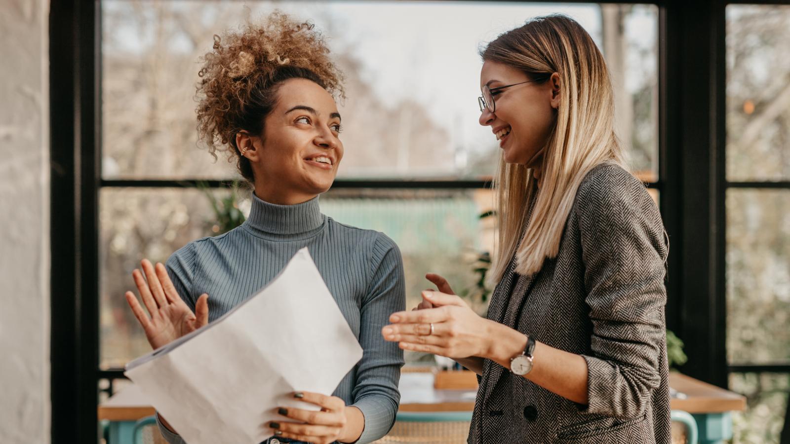Two young women with documents