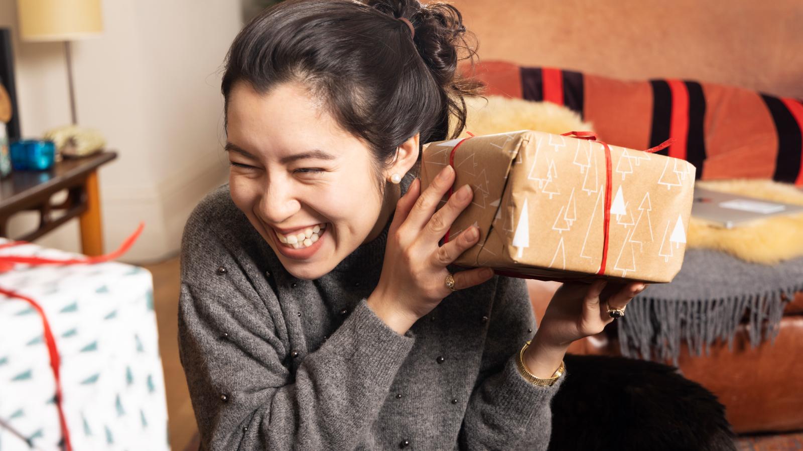 Woman shakes present to guess