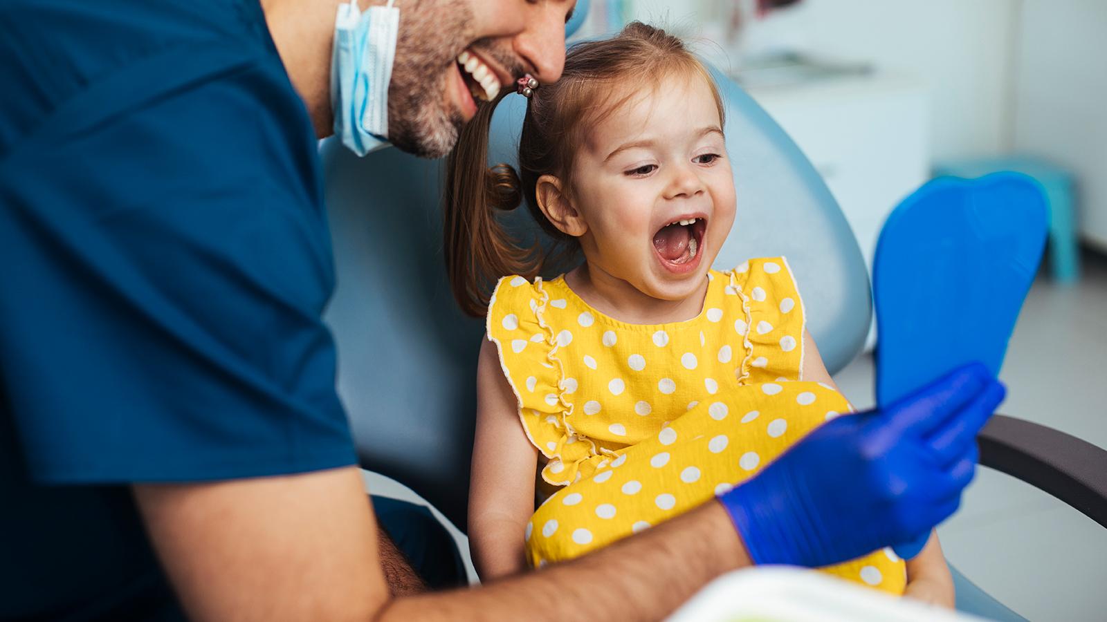 Dentist with a little girl patient