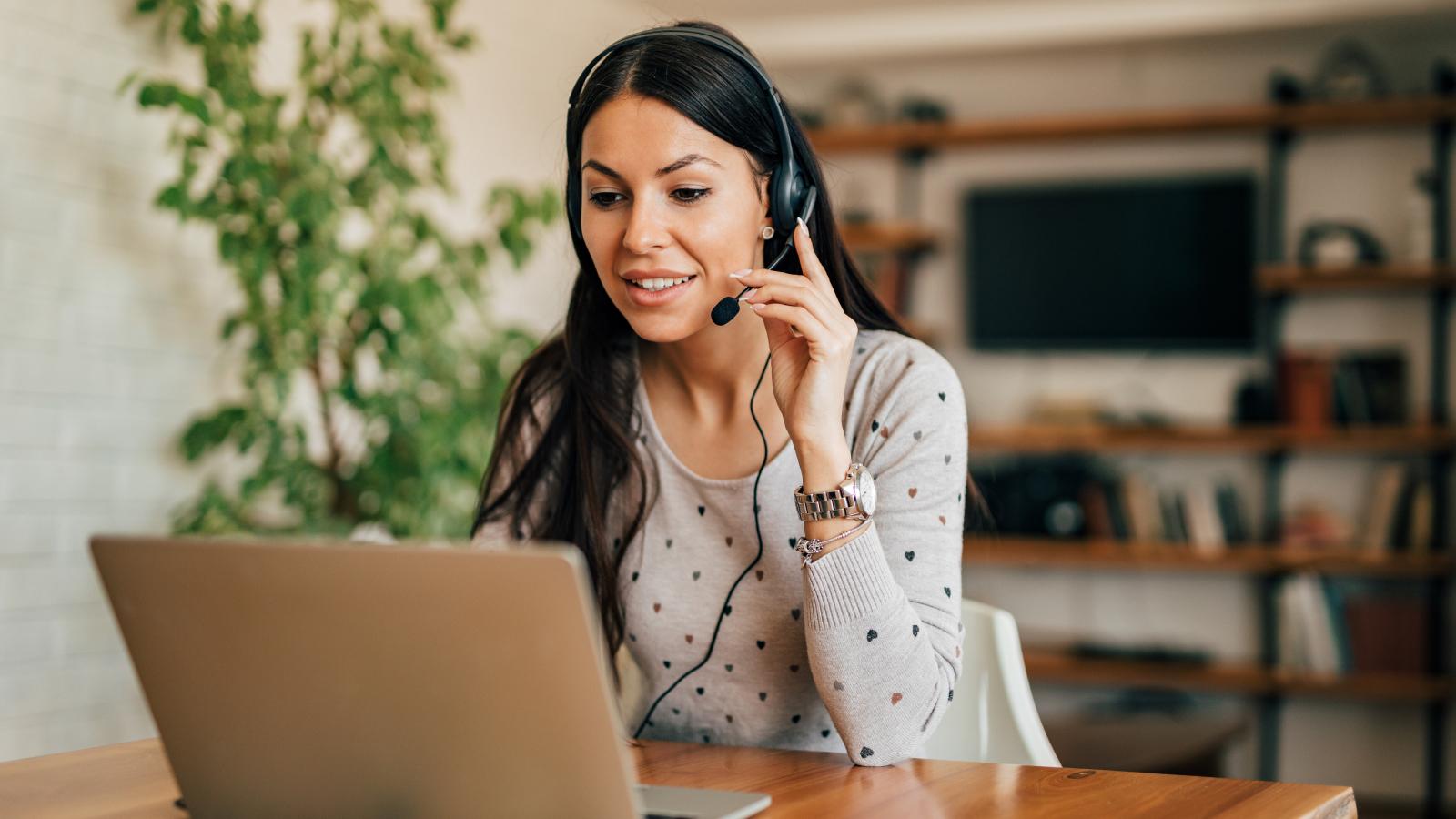 Woman with headset and laptop