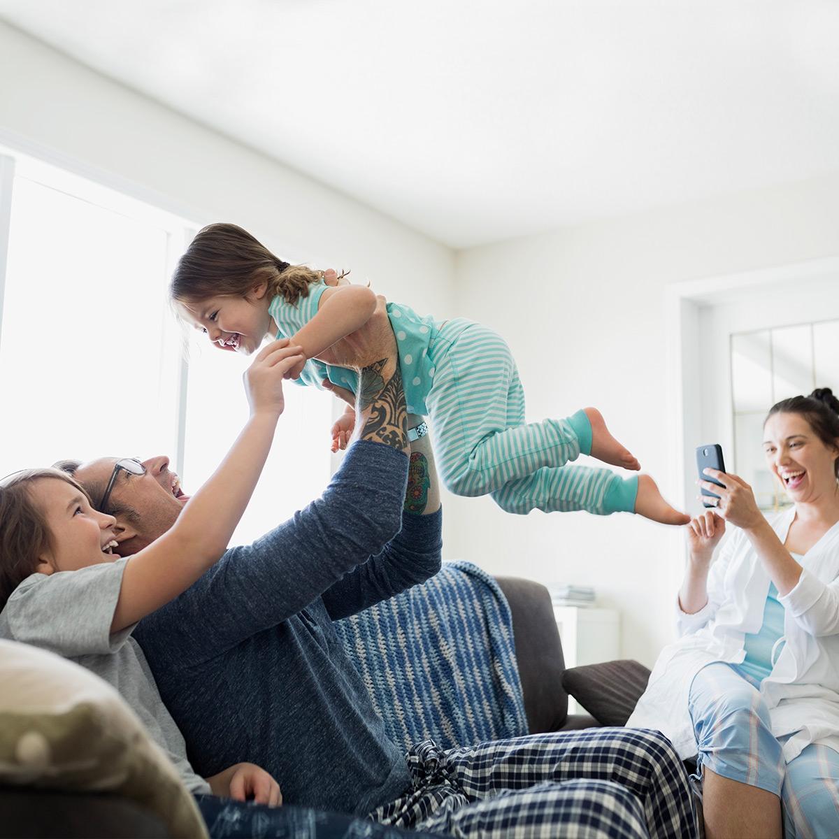 Family of four enjoying at home.