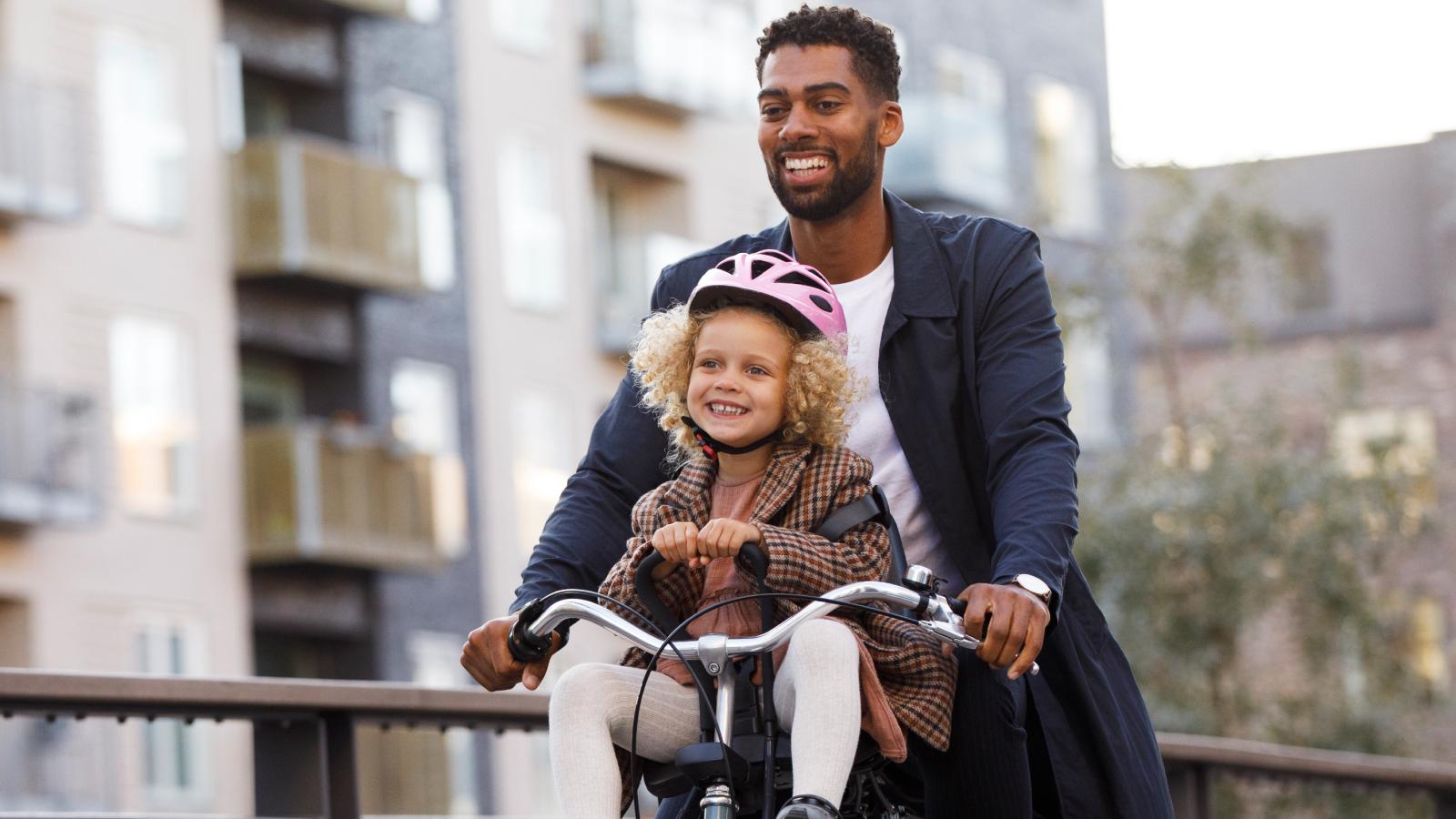 Father and daughter riding on a cycle