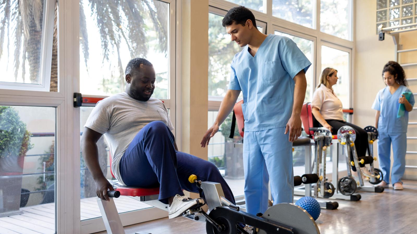 Physiotherapists helping patients at a rehabilitation center