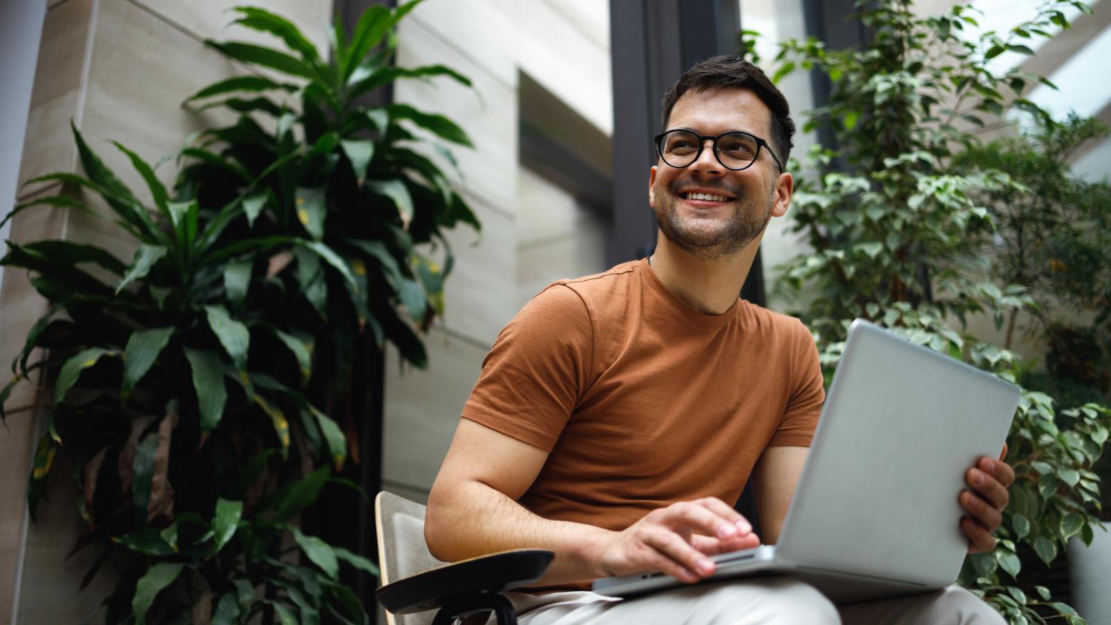 Man smiling with laptop