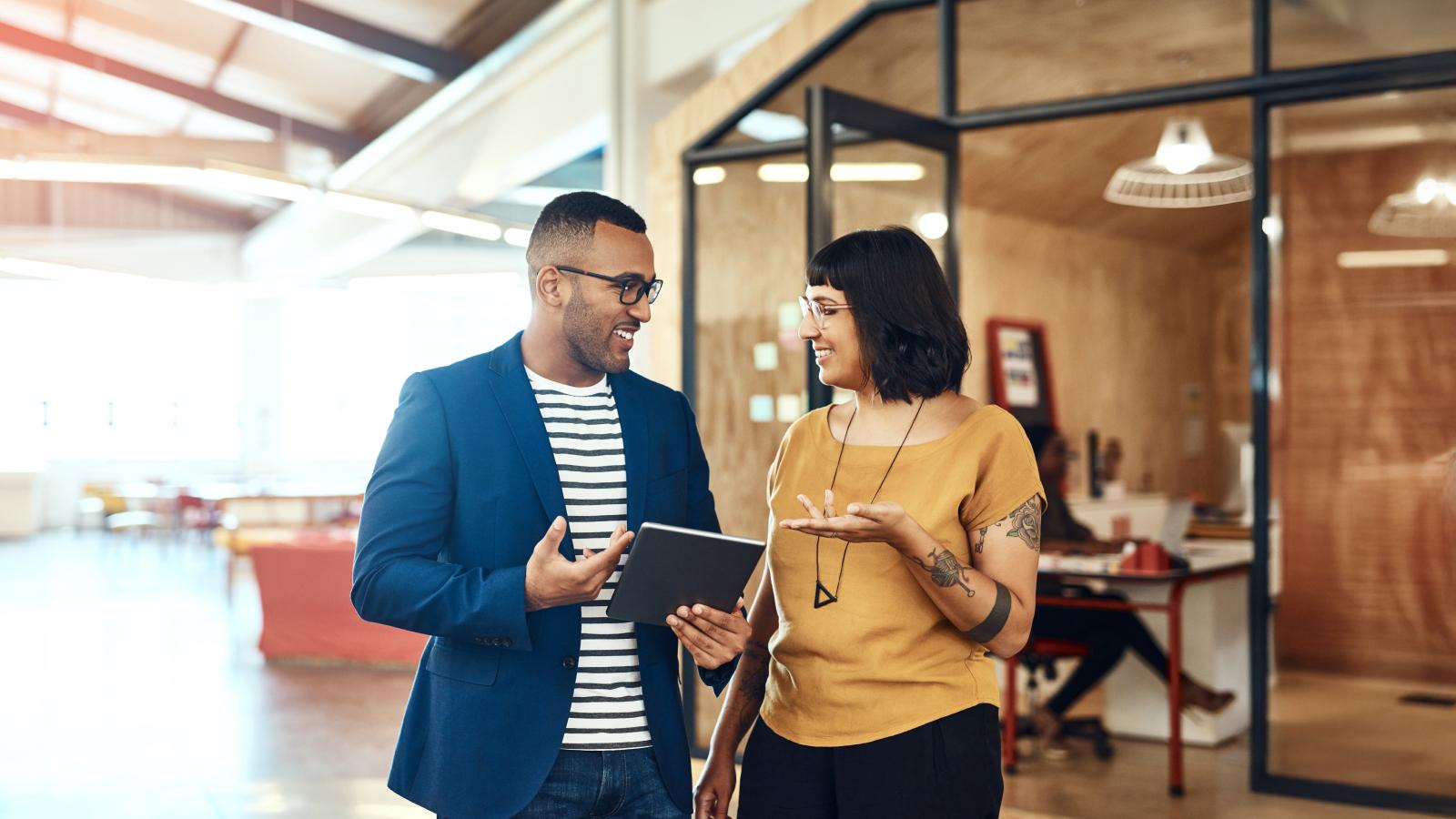 Two designers working on a digital tablet