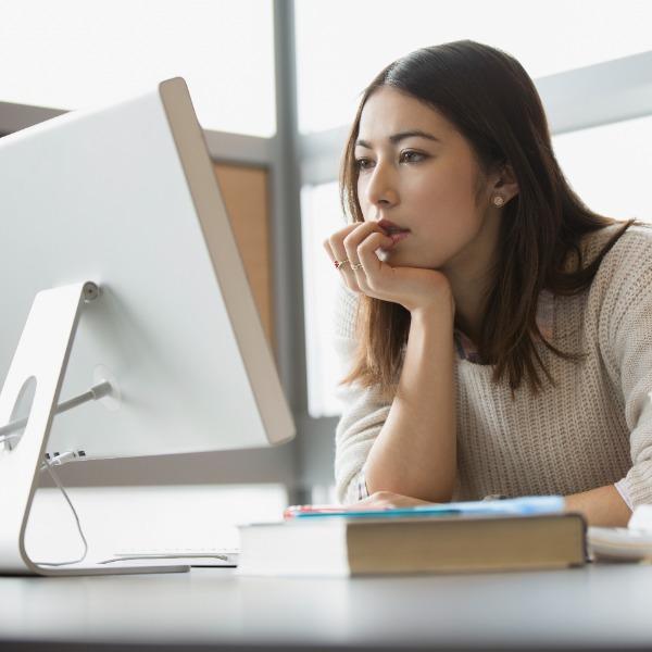 Woman seriously reading about insurance online.