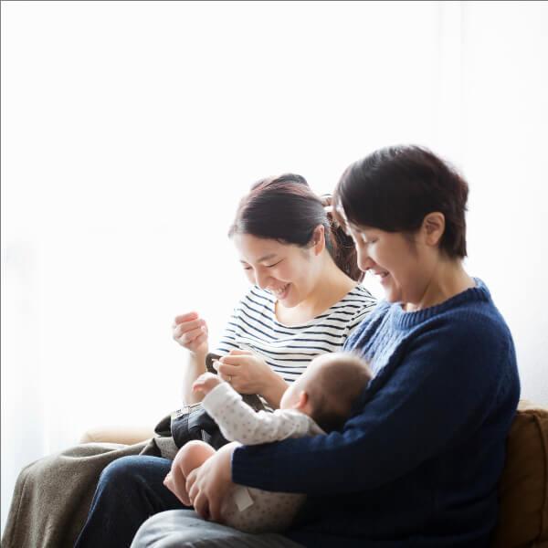 Mother and grandmother holding a baby.