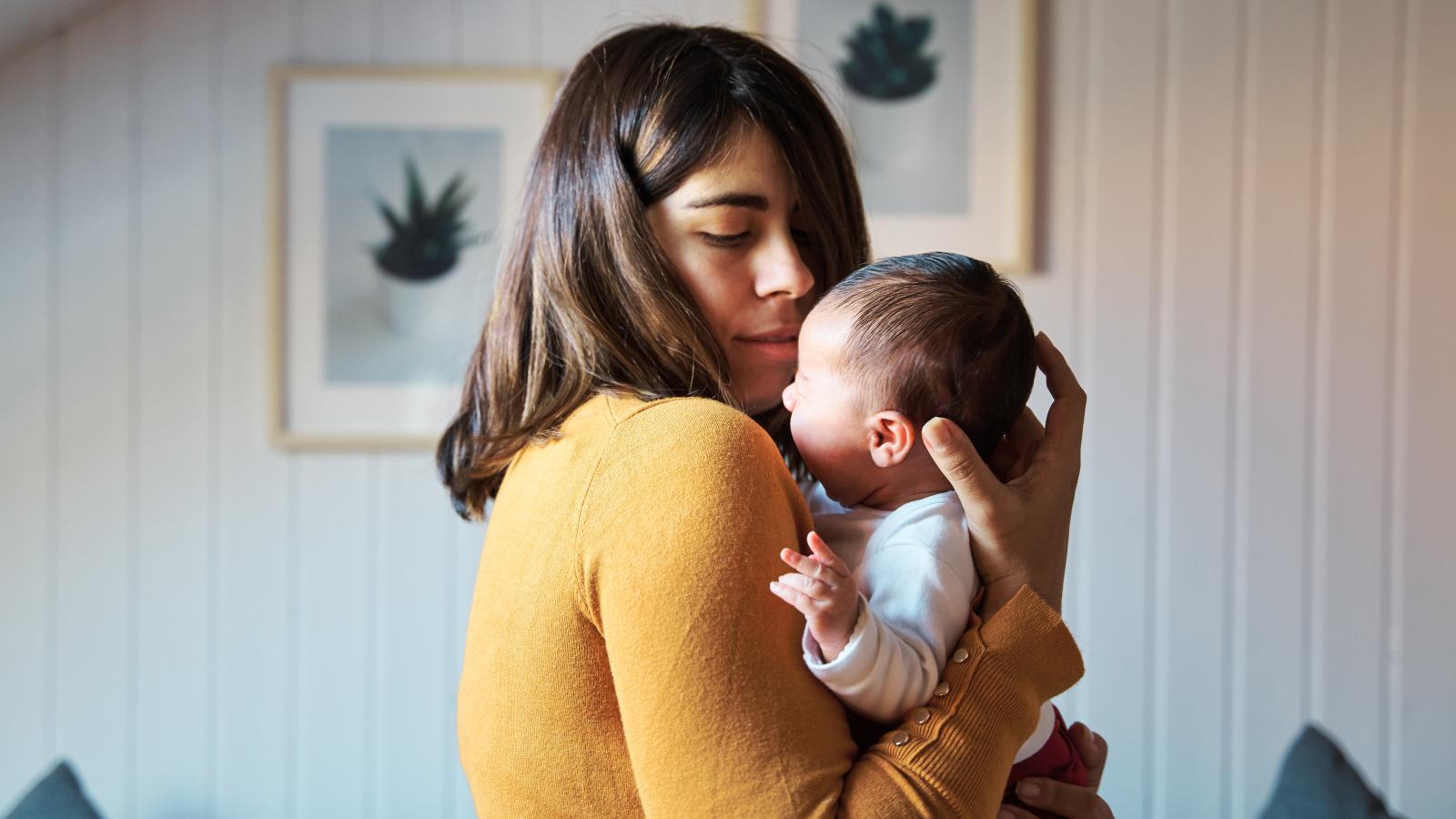 Mother comforting her newborn