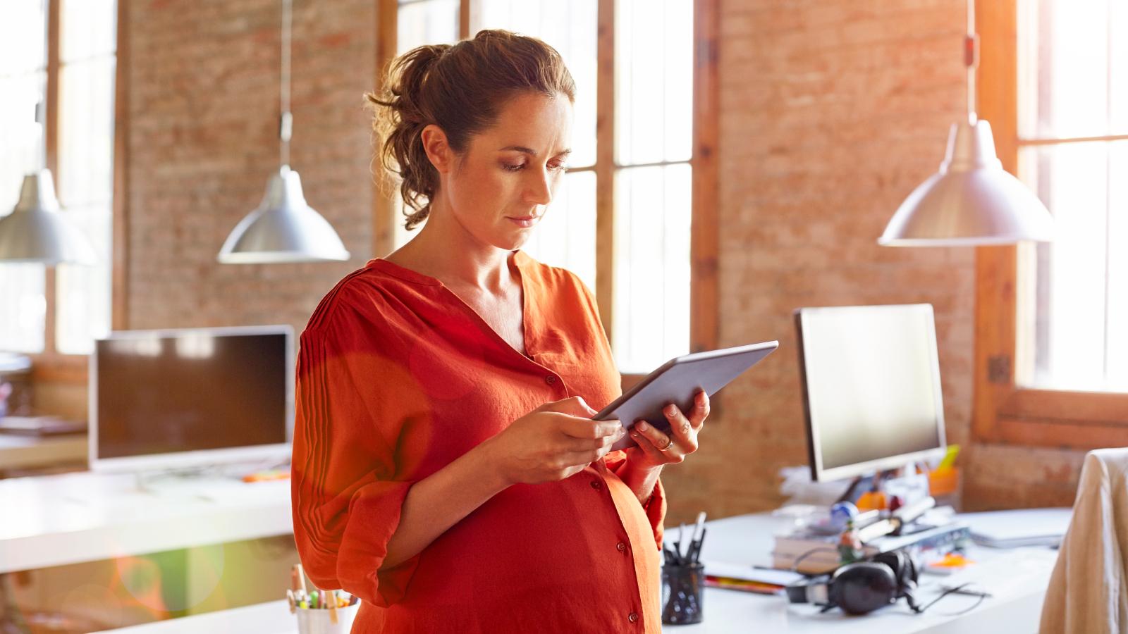 Pregnant woman using tablet
