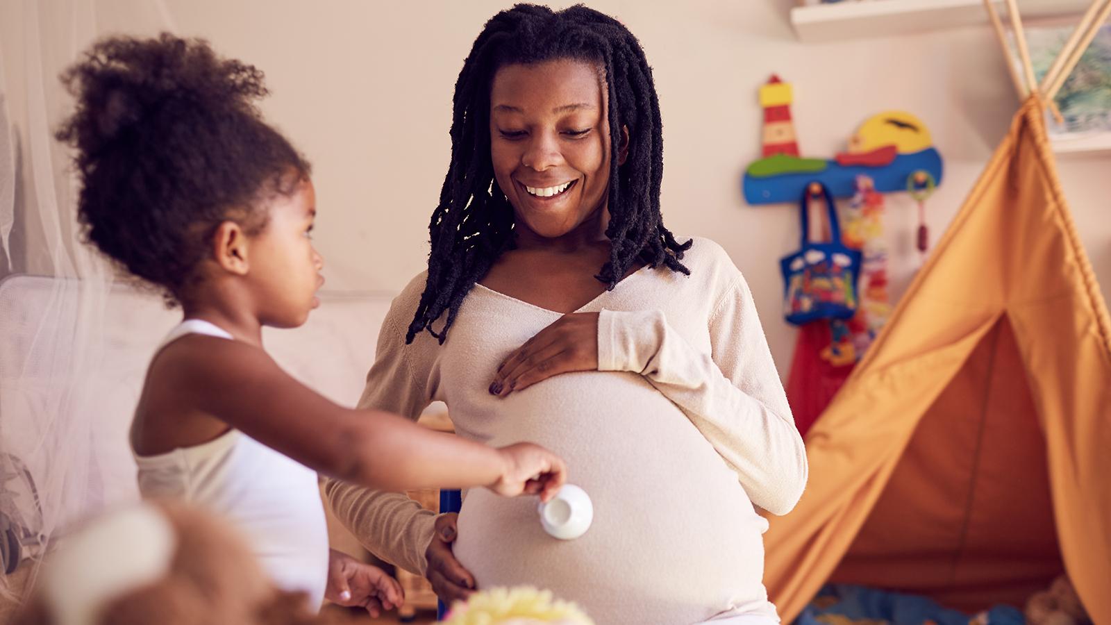 Pregnant mom with daughter.