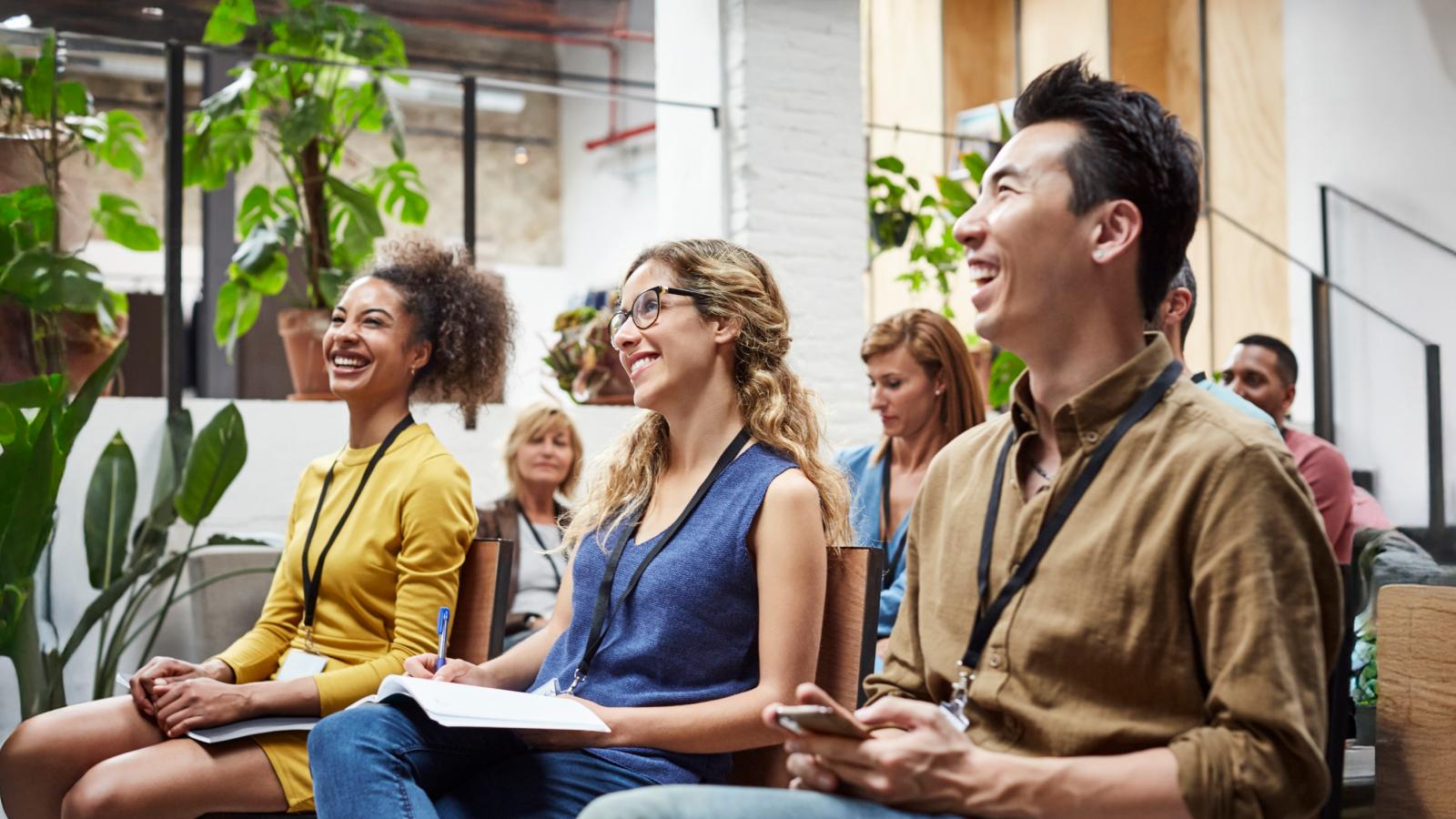 Multi ethnic business people smiling in seminar