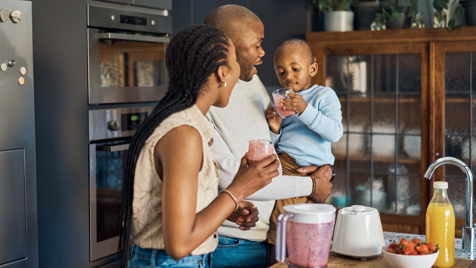 Family enjoying fruit smoothie breakfast