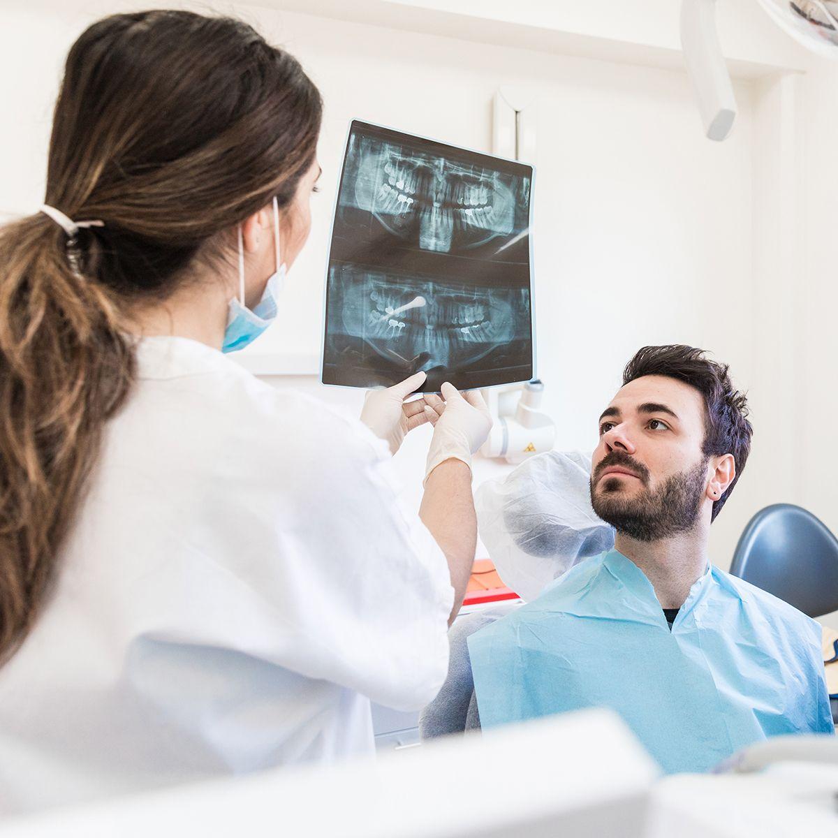 Patient with his dentist reviewing his x-rays.