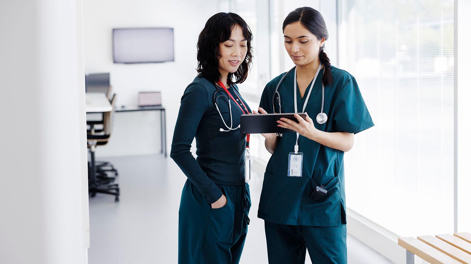 Female nurses looking at a tablet