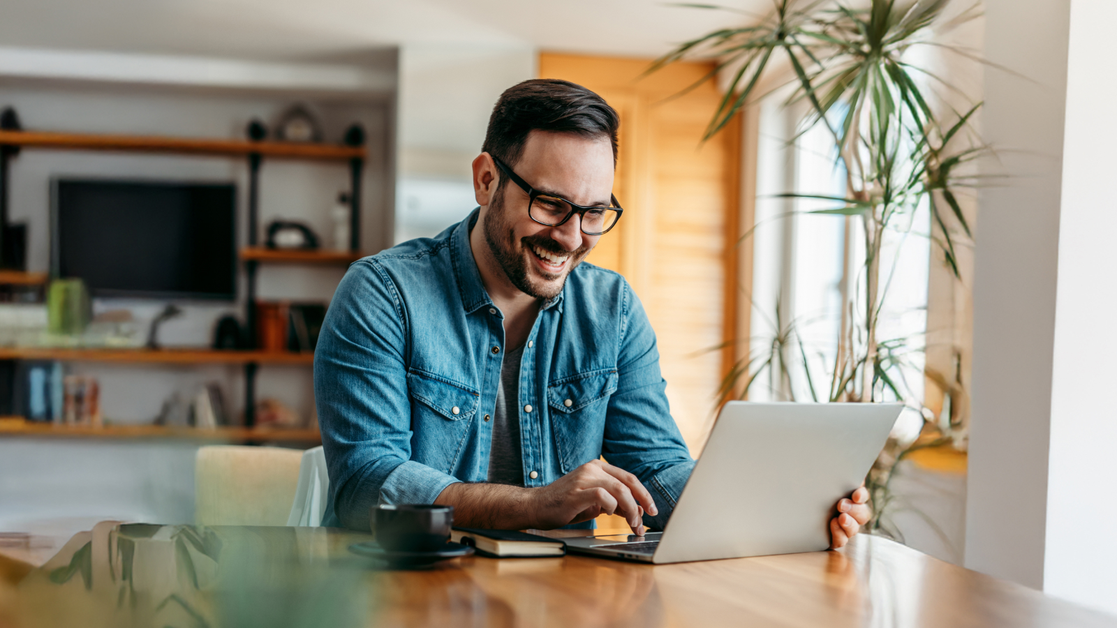 Joyful man working on his computer.