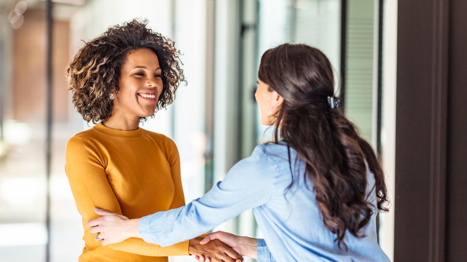 Two successful businesswomen shaking hands