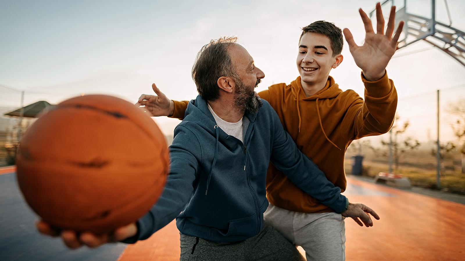 Father and son playing basketball together