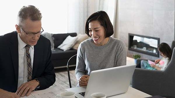 Mother review life insurance policies with financial advisor.