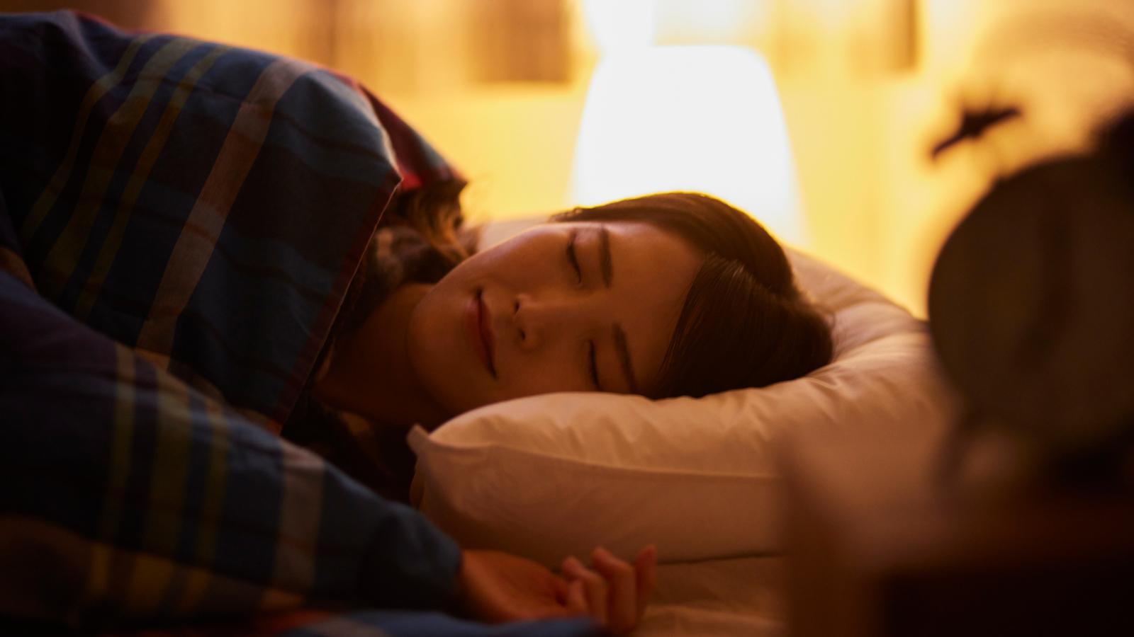 Woman sleeping in her bedroom
