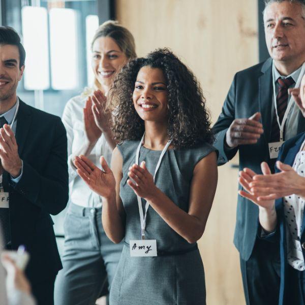 Group of employees clapping.
