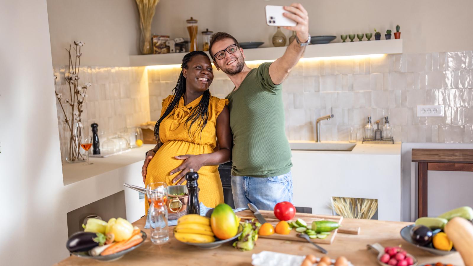 Happy pregnant couple in the kitchen