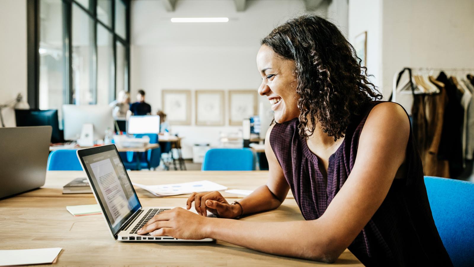 Woman working on her laptop in an office.
