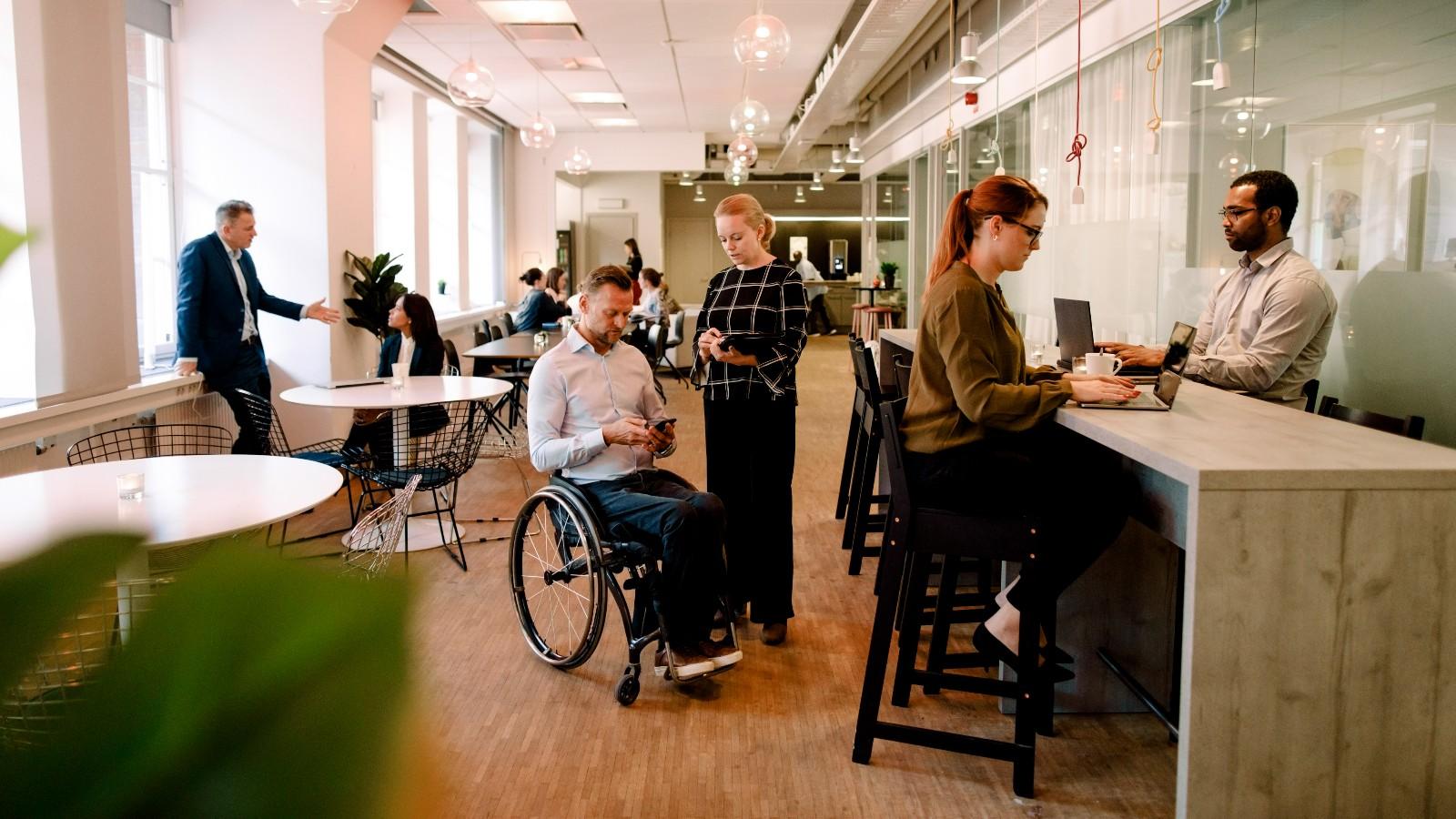 business colleagues talking and working in office cafeteria
