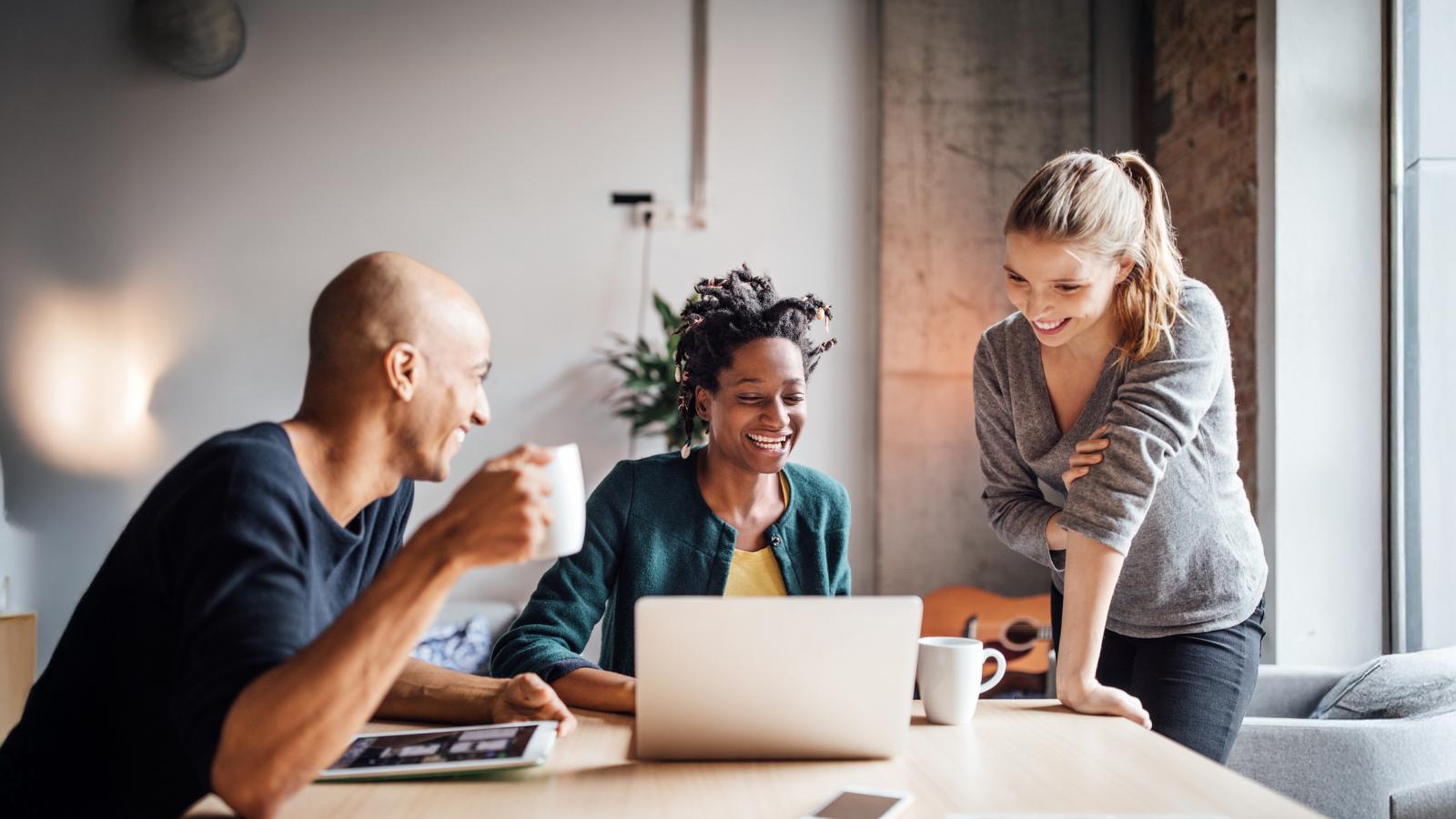 Business people looking at laptop