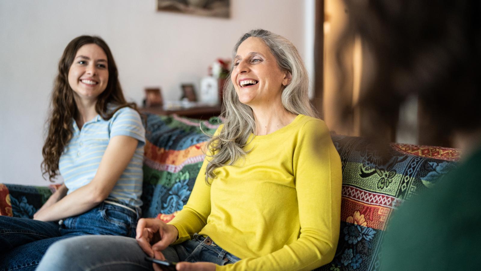 Mother and daughters talking at home