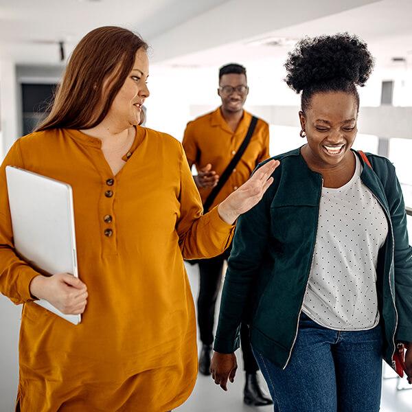 Co-workers walking together through a walkway.