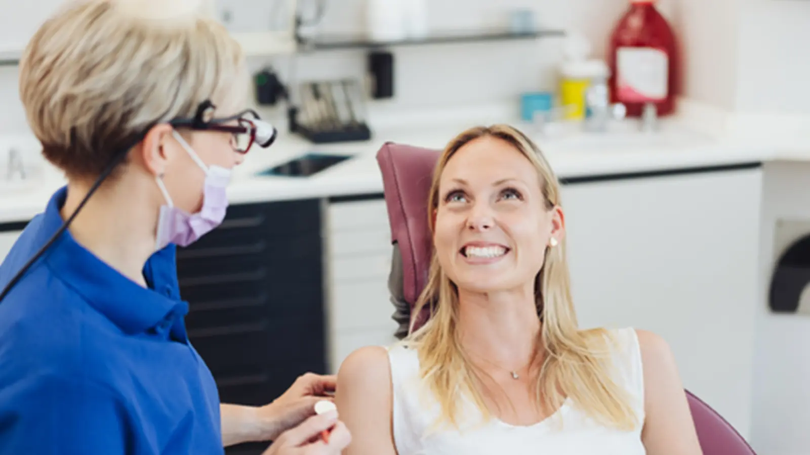Dentist with an adult female patient during a check up. Dentist with an adult female patient during a check up.