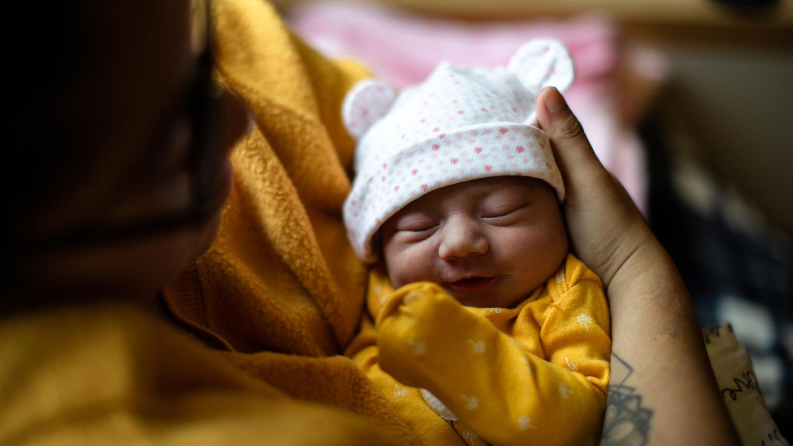 Mother holding her newborn baby.