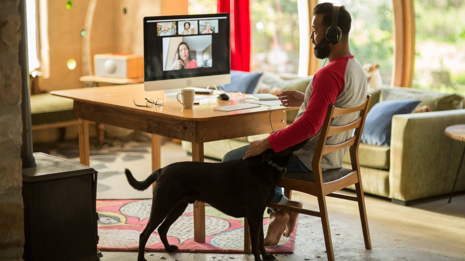mixed race man working from home on his computer during lockdown