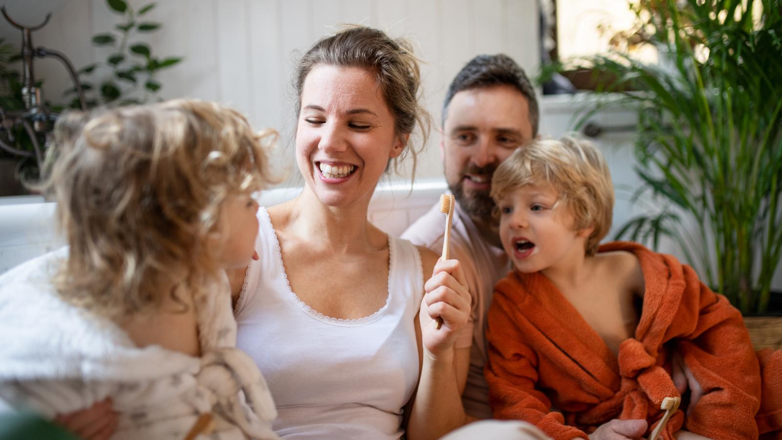 Parents smiling with children on the couch