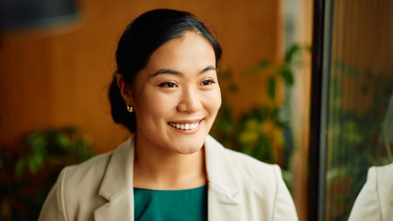 Businesswoman smiling in an office. Businesswoman smiling in an office.