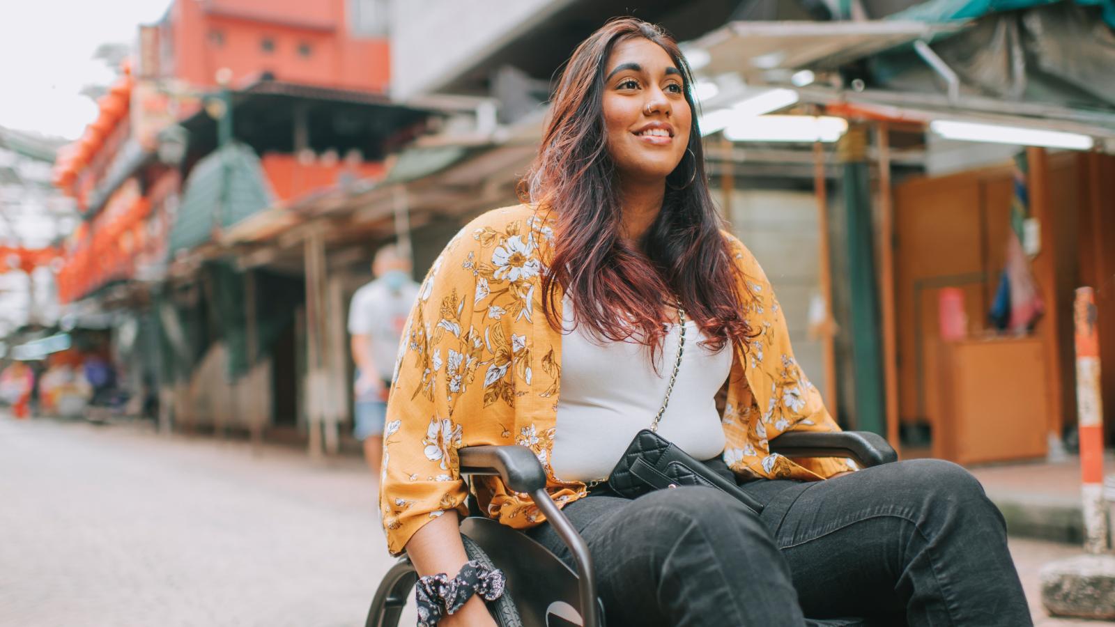 Woman in a wheelchair outside. Woman in a wheelchair outside.