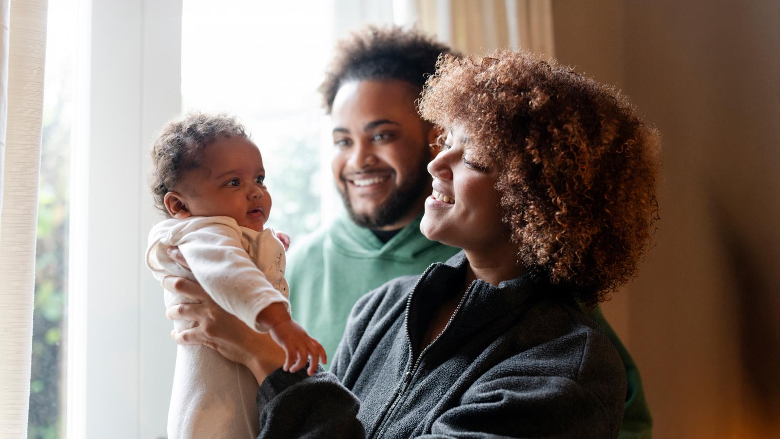 Parents looking at baby daughter