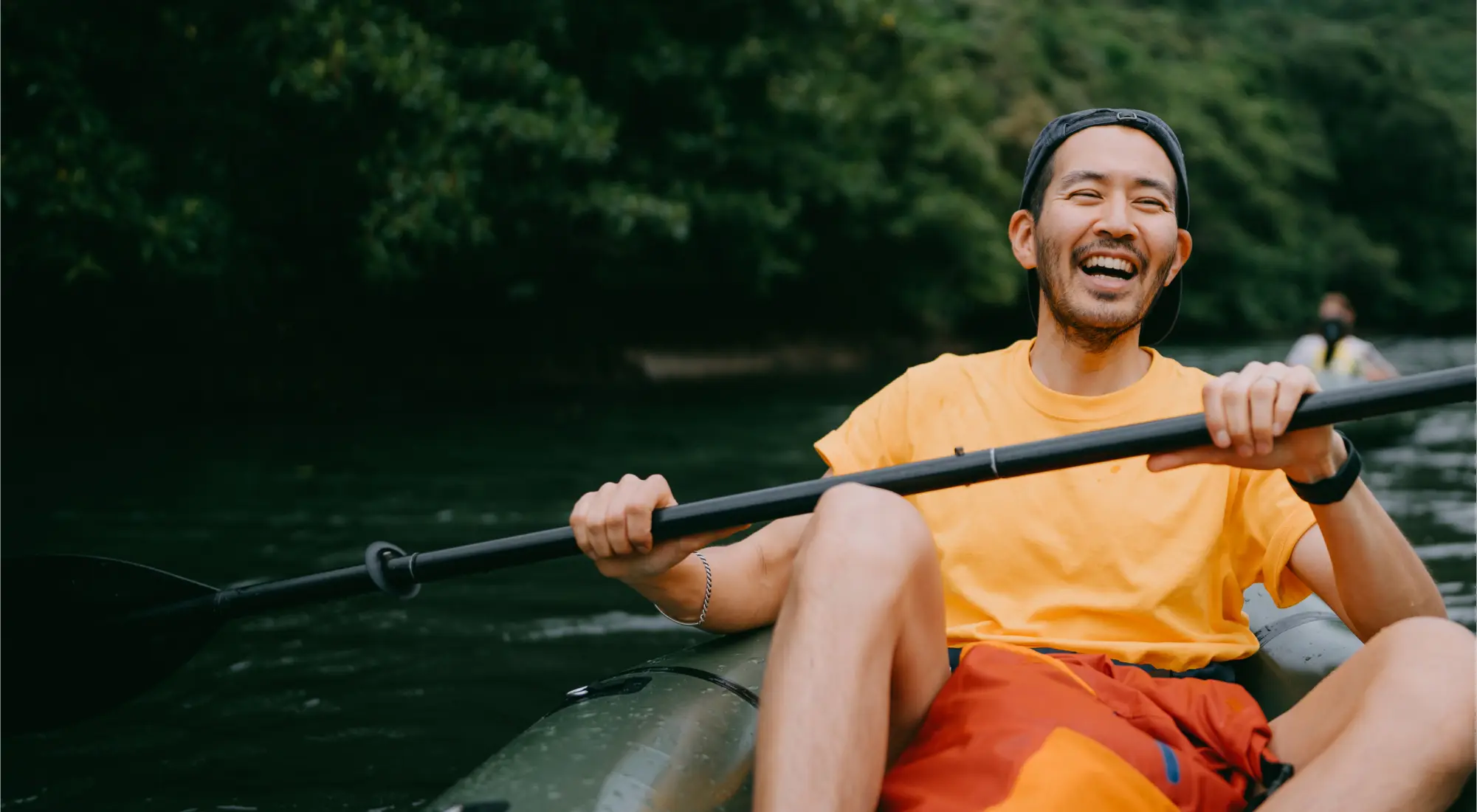 Happy man kayaking down a river Happy man kayaking down a river