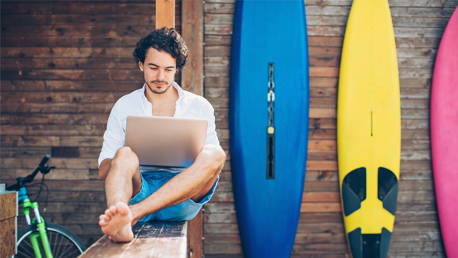 A man working remotely at the beach