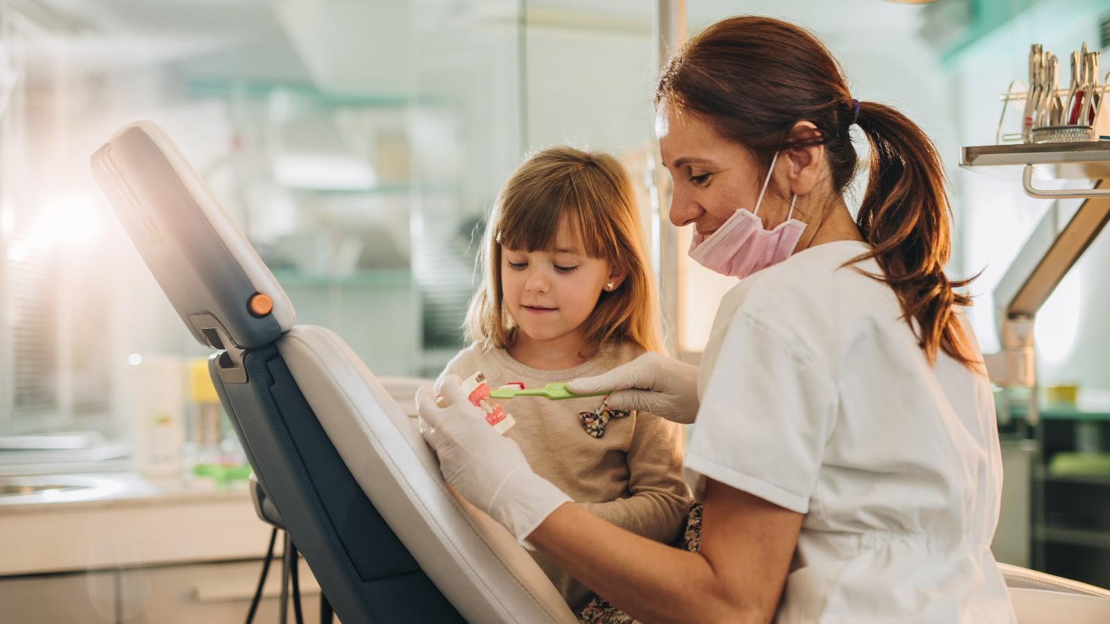 Female dentist explaining to a child