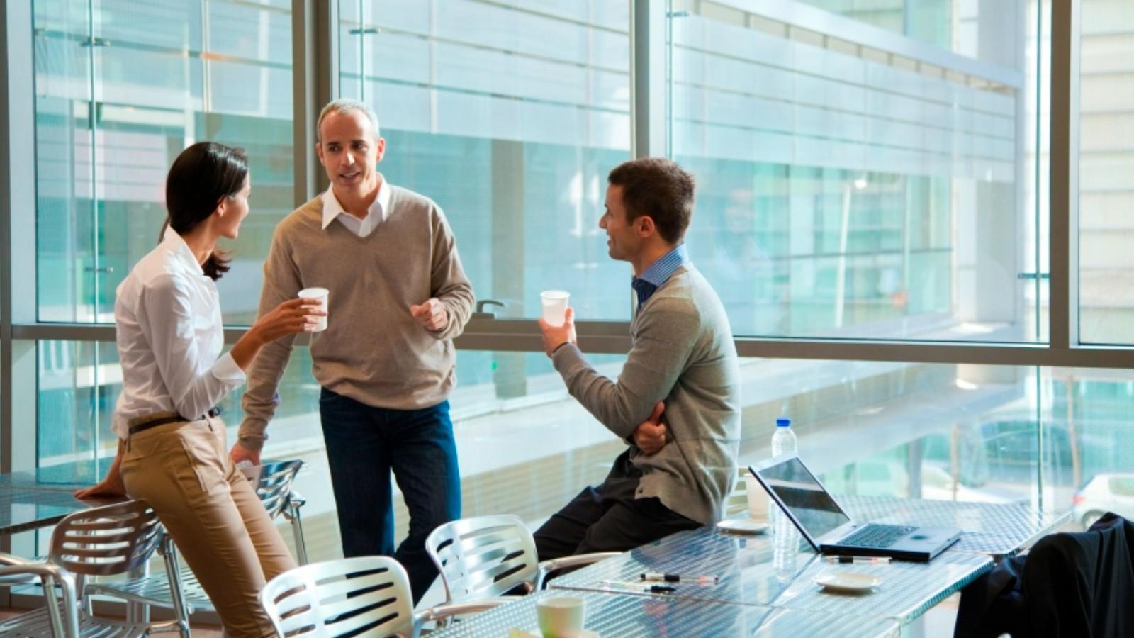 Colleagues chatting in office meeting