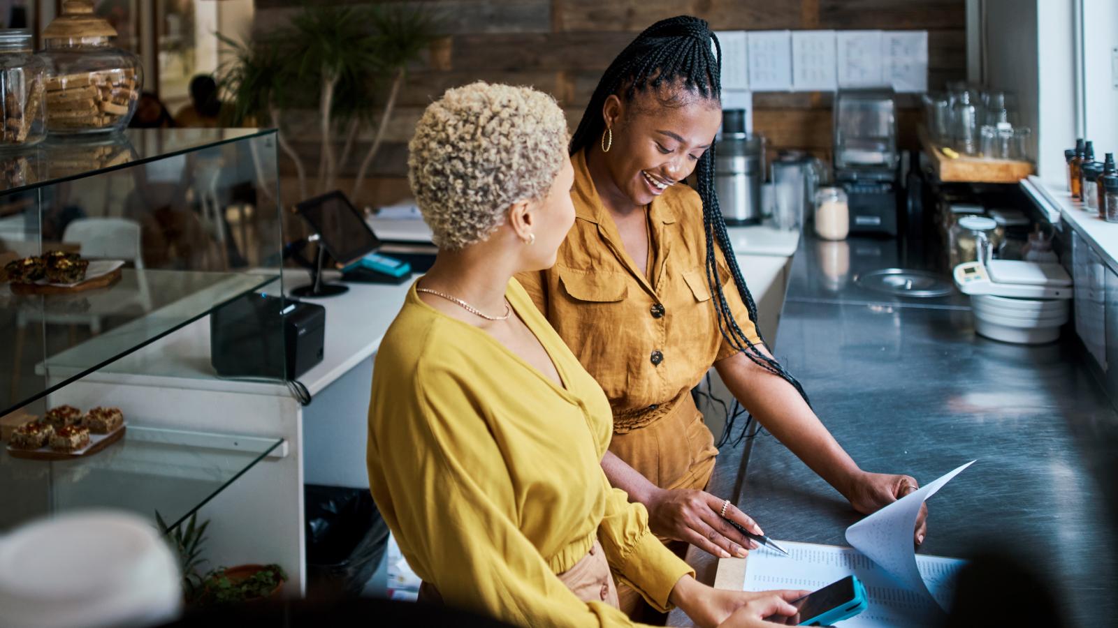 Two businesswomen discussing their workplace
