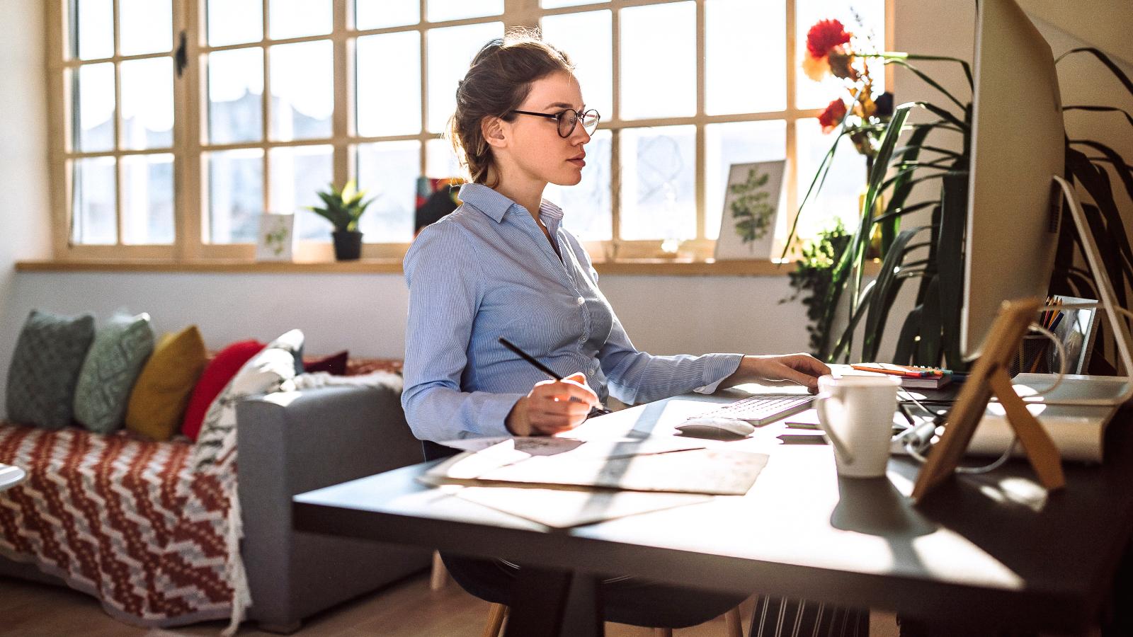 Woman drawing sketches and using computer