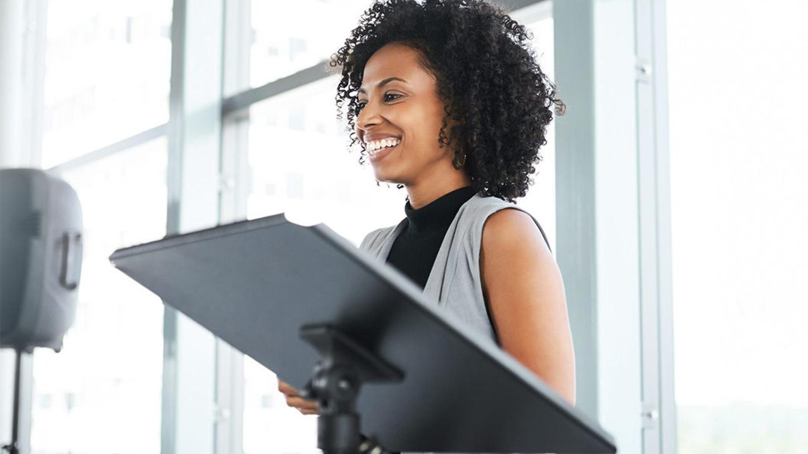 Woman speaking in front of a meeting
