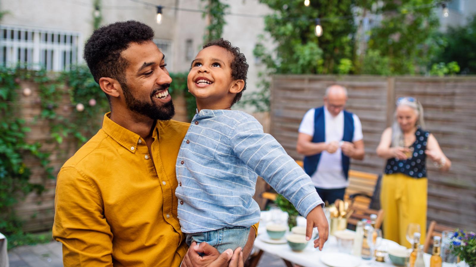 A father smiling with his young son.