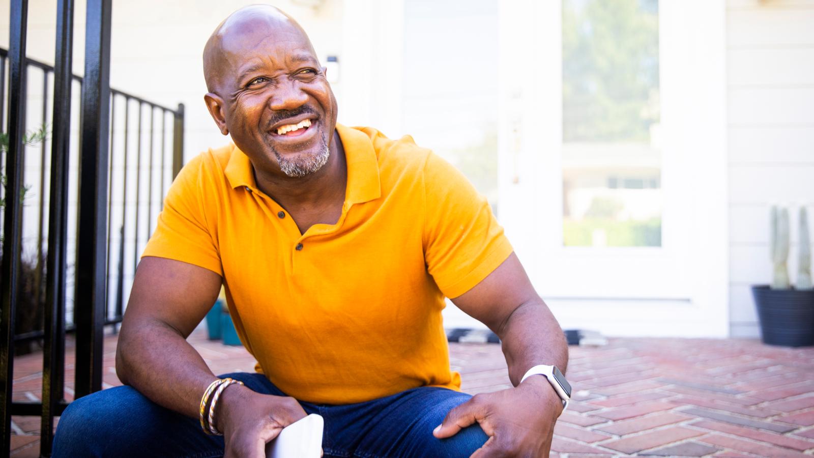 Older man sitting on his front porch with a cup of coffee. Older man sitting on his front porch with a cup of coffee.