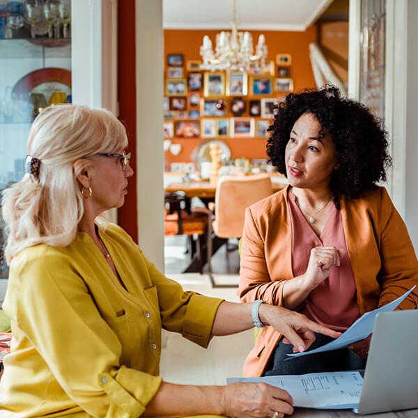 Female financial representative meeting with her client at her home